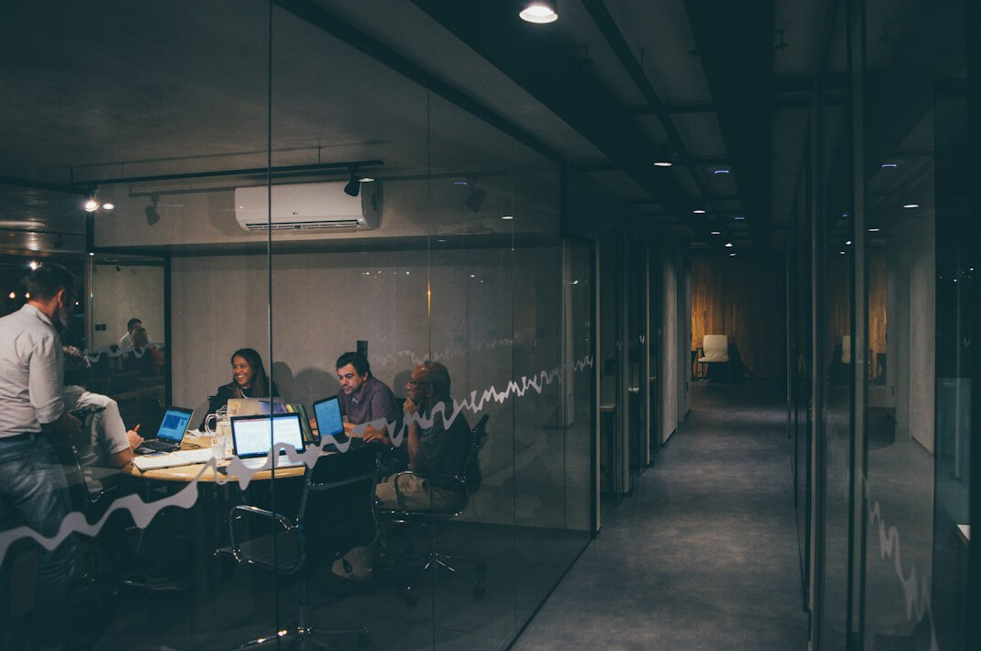 team of programmers collaborating in office